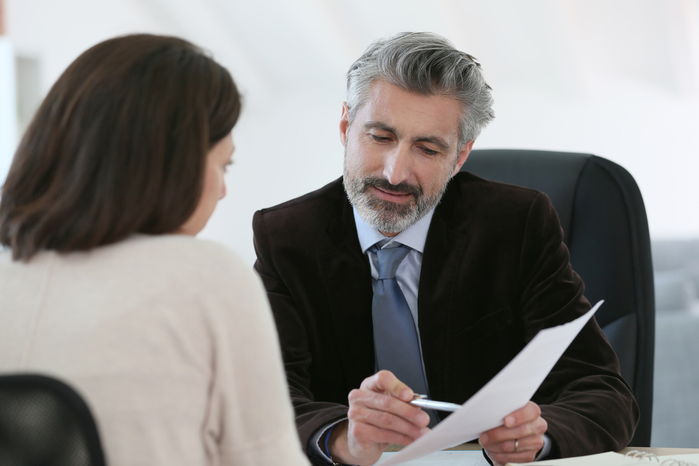 lawyer discussing paperwork with client